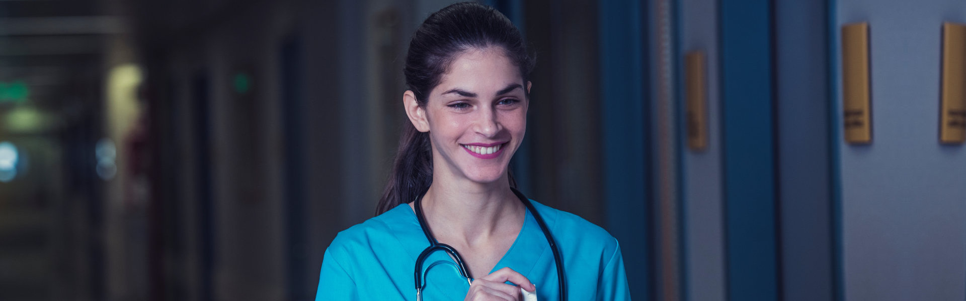 nurse smiling in the hallway